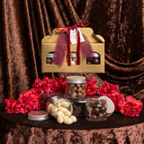 cajita dorada premium con botes de frutos secos bañados en chocolate para regalar